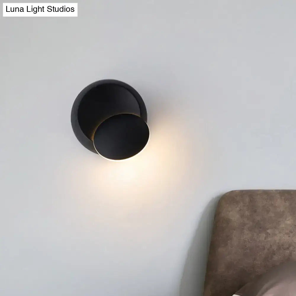 Black matte wall light with modern minimalist concentric circles designed for white yellow led bedroom lighting