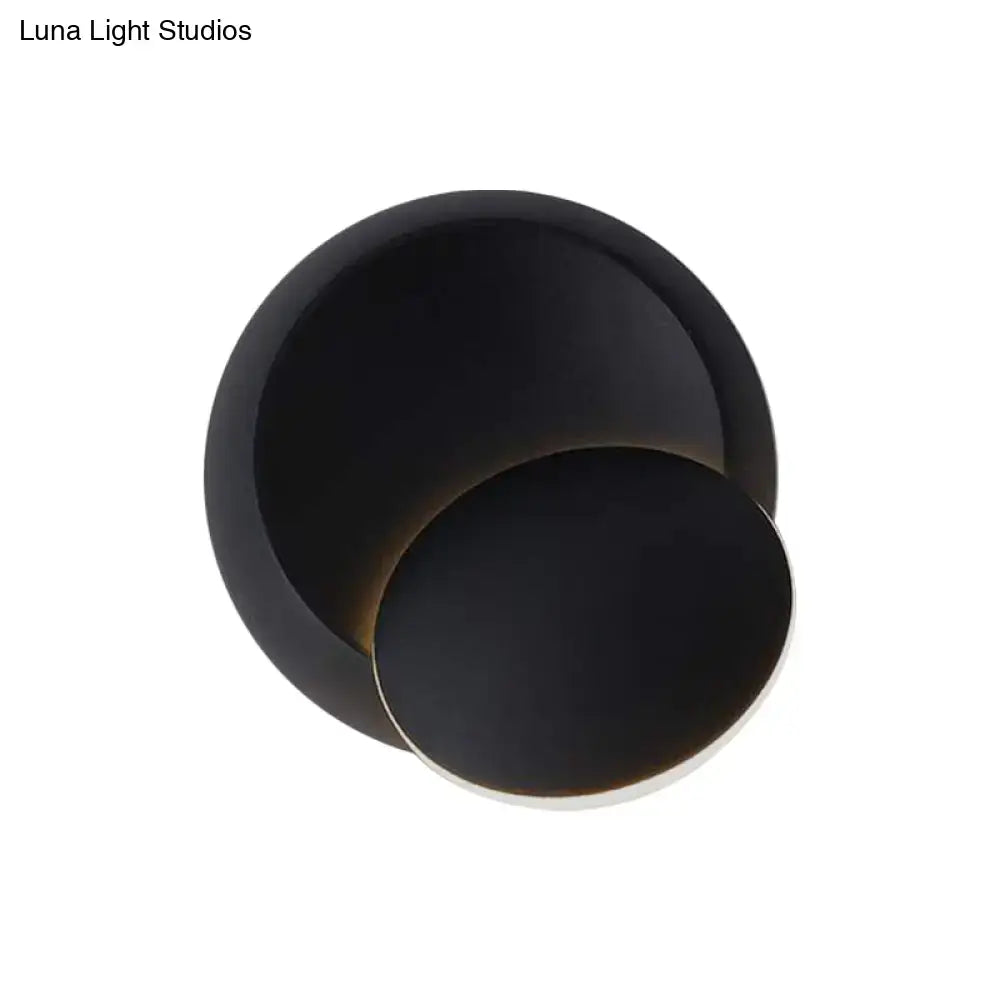 Black matte circular wall light with overlapping concentric rings featuring white yellow led illumination