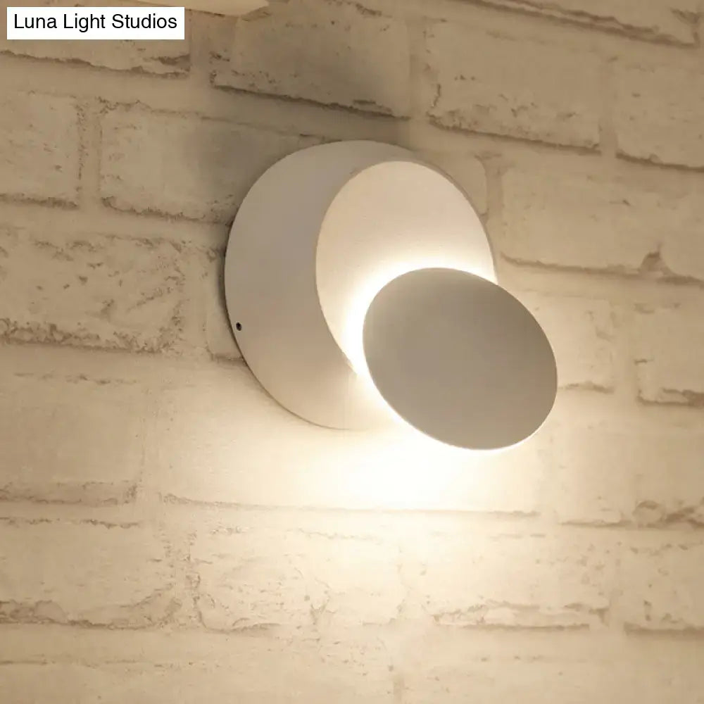 Modern white circular wall sconce with sleek minimalist design featuring white yellow led wall light for bedroom use