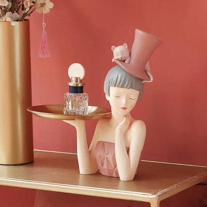 Delicate porcelain sculpture tray featuring a modern pink and gray woman holding a golden tray for home decor by decorbites