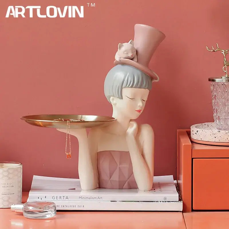 Pastel pink and gray resin sculpture tray of an elegant woman with short hair and top hat holding gold tray for home decor