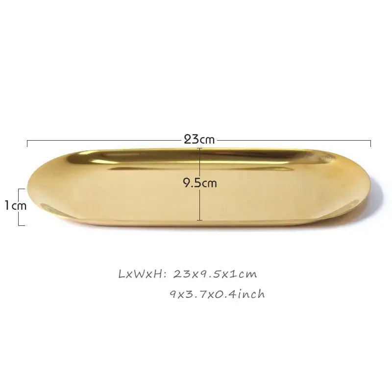 A sleek oval gold metal sculpture tray with a reflective surface ideal for modern home decor and decorbites elegant woman display