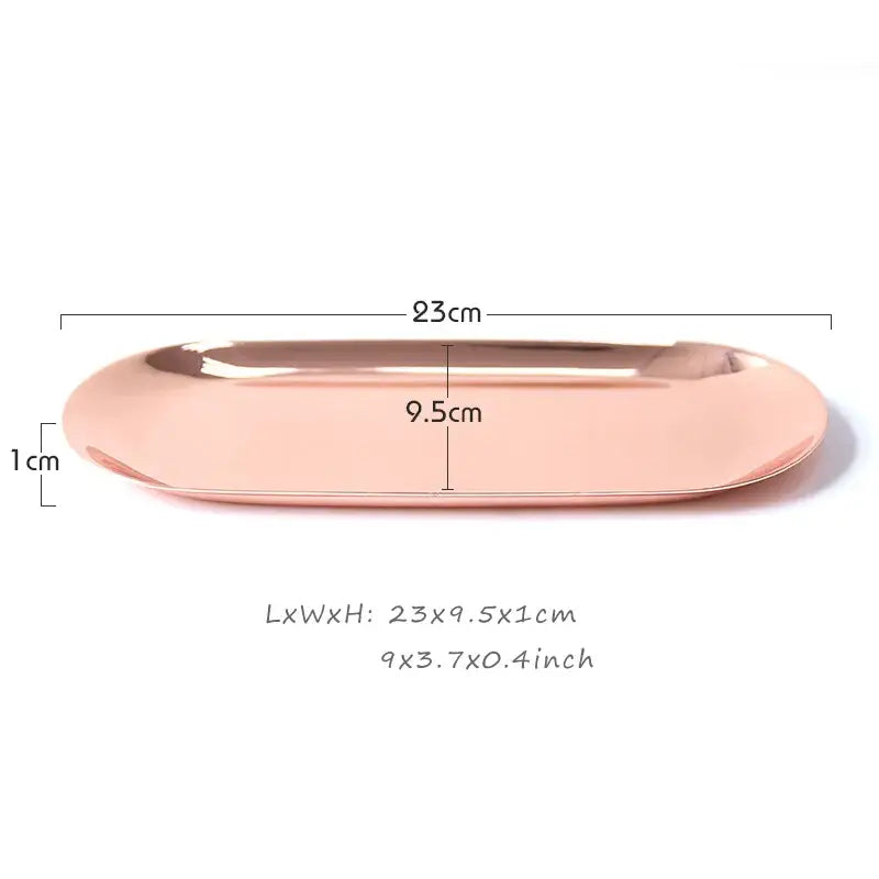 A sleek rose gold metallic oval sculpture tray with smooth reflective surface and rounded edges for modern home decor