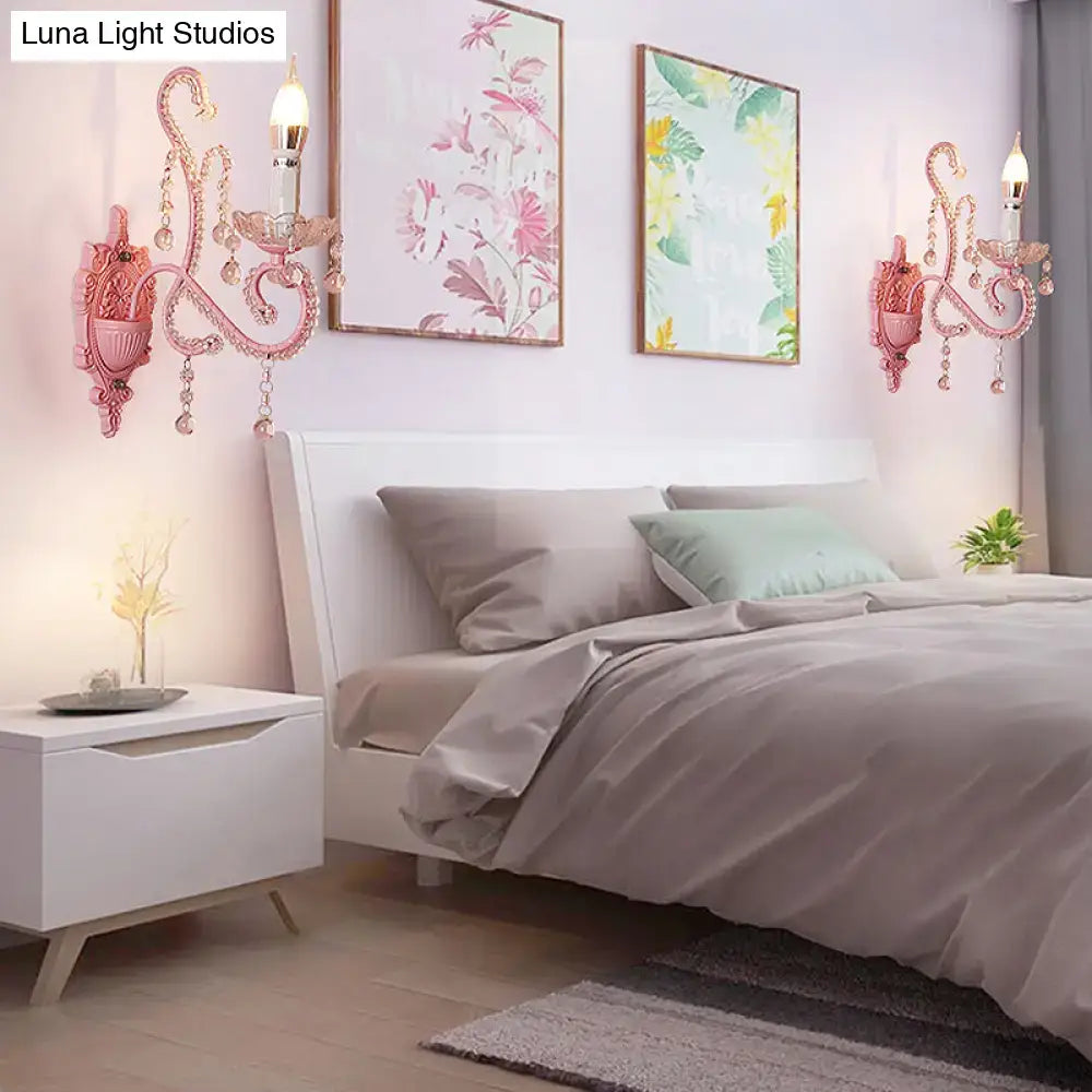 Modern pink metallic scroll arm wall lamp with crystal accents featuring ornate wall sconces for bedroom use