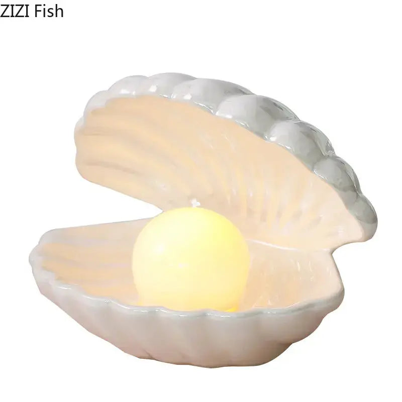 Modern pink and off-white pearl shell lamp desk decoration with glowing yellow pearl and smooth ceramic exterior