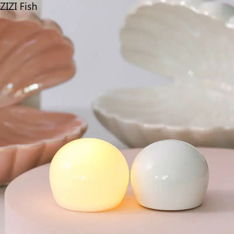 Two spherical led nightlights in warm yellow and matte white with glossy surfaces for lamp desk decoration