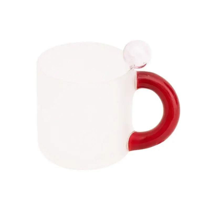 A frosted white glass mug with a glossy red handle and clear spherical accent in a modern glass mug set