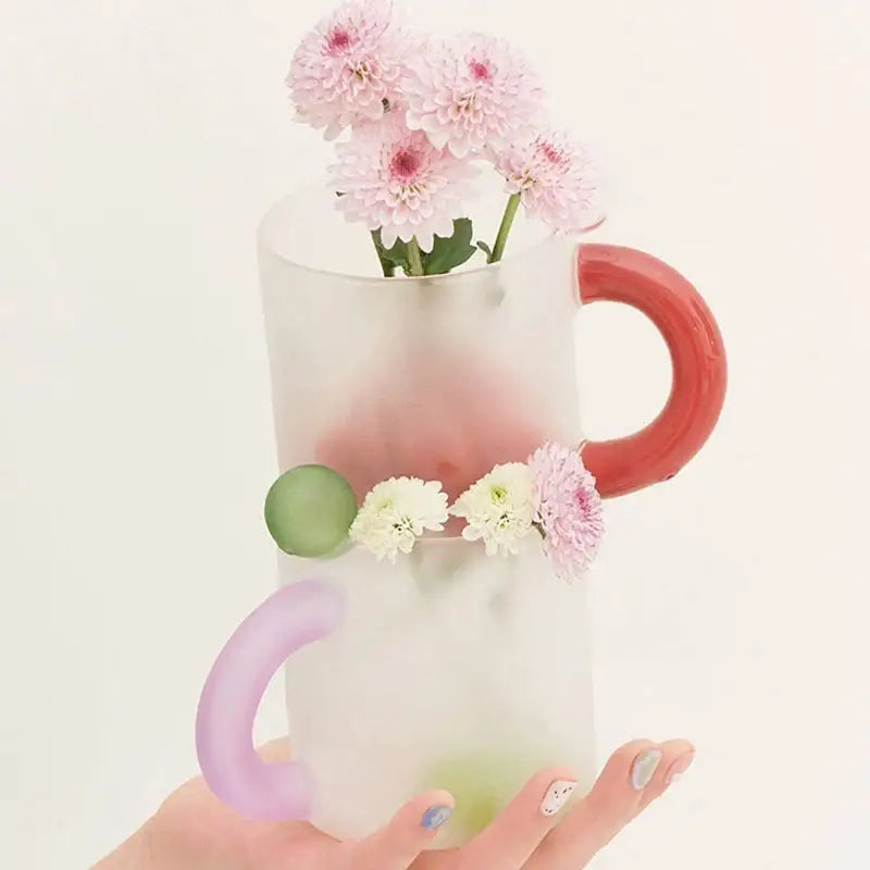 Translucent frosted glass mug with red and lavender handles featuring pink and white chrysanthemums in a mug set