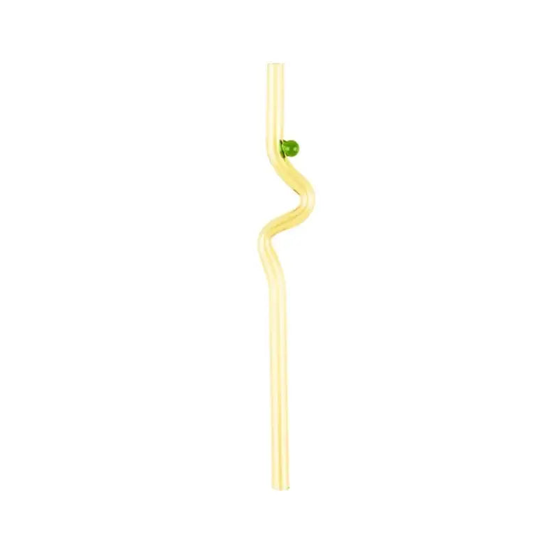 A translucent yellow glass straw with a wavy design and green bead beside a modern pink and red glass mug set