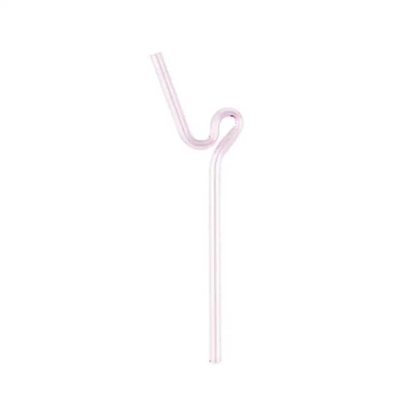 A translucent pink glass straw with a curved ergonomic design in a modern pink and red glass mug set for dining and dessert