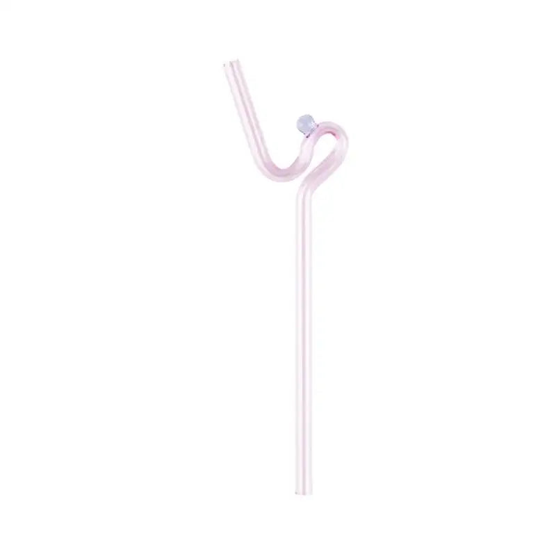 A translucent pink glass straw with curved ergonomic design and spherical cap in modern pink and red glass mug set