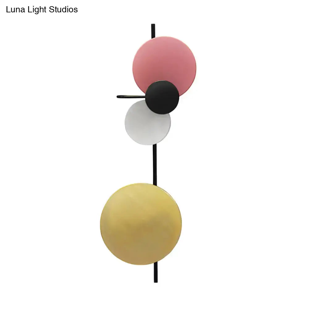Modern geometric circular wall mount light with pink silver and gold spherical shades for living room use