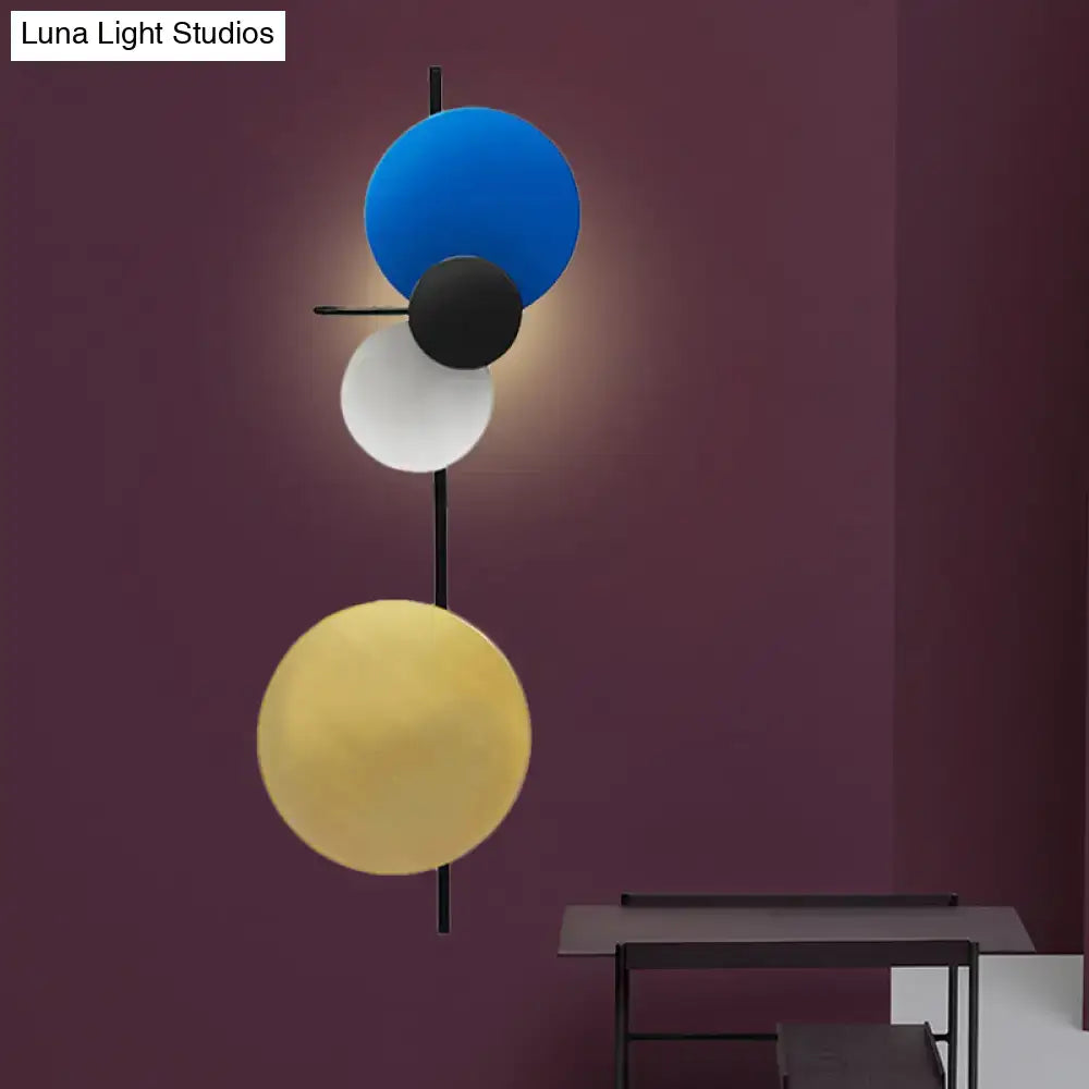 Modern pink silver and gold circular wall mount light with geometric blue black and gold spherical shades for living room
