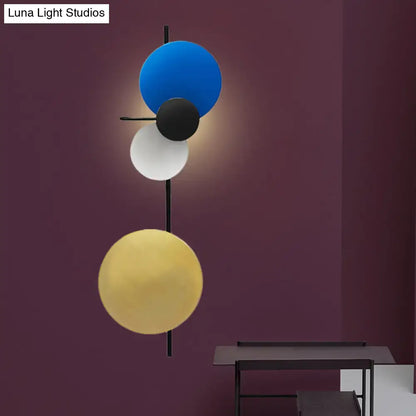 Modern pink silver and gold circular wall mount light with geometric blue black and gold spherical shades for living room