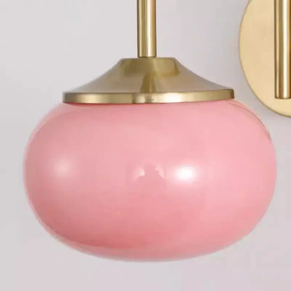 Modern pink and white glass ball wall lamp featuring a soft pink spherical glass pendant with polished brass fixture decorbites glass ball wall lamp