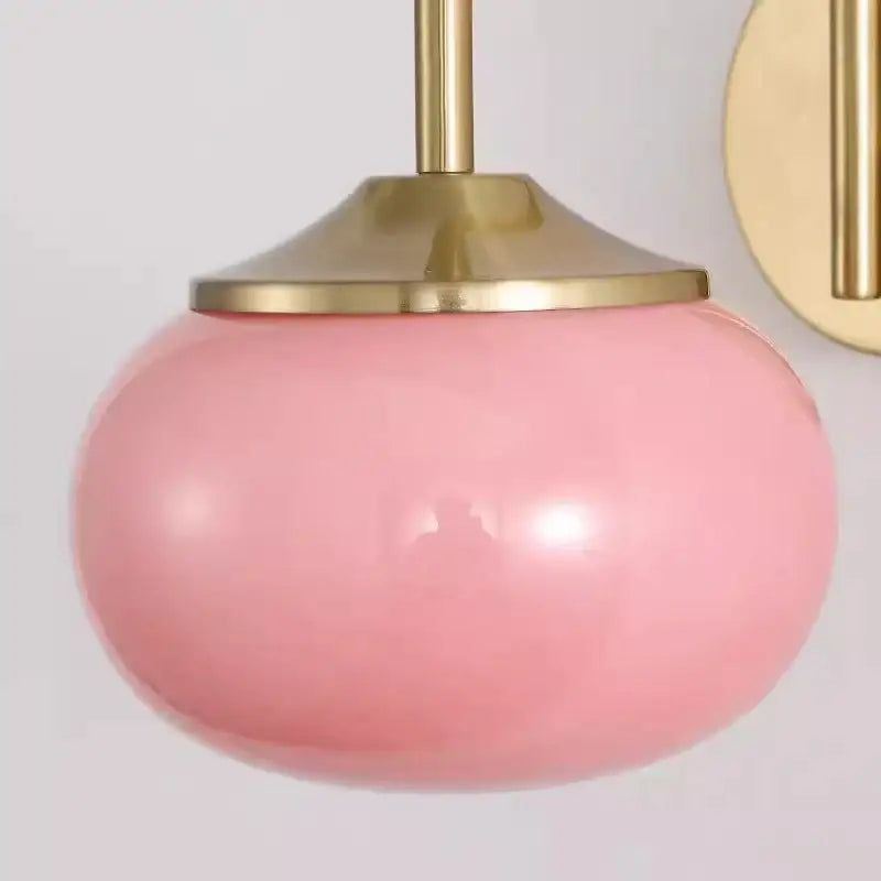 Modern pink and white glass ball wall lamp featuring a soft pink spherical glass pendant with polished brass fixture decorbites glass ball wall lamp