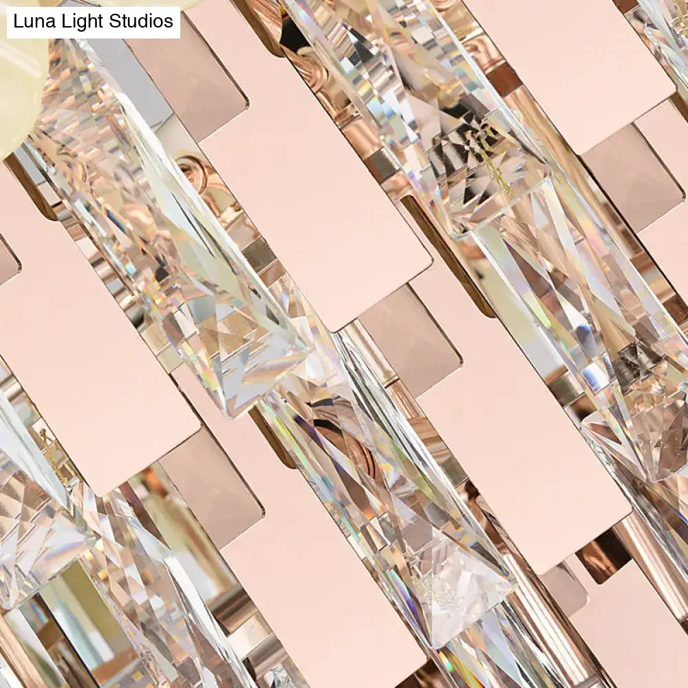 Modern pink and yellow clear crystal chandelier with faceted prisms and rose gold accents for dining room pendant lighting