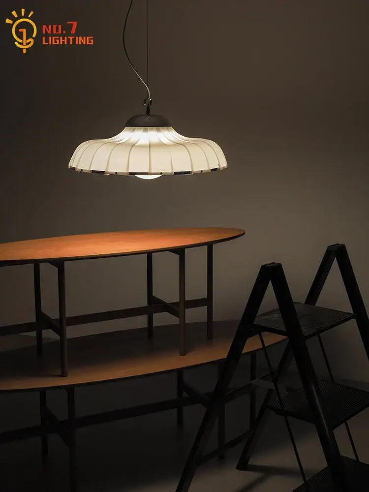 Modern pleated off white double diffuse pendant lights with paper shade and dark metal frame over oval wooden table