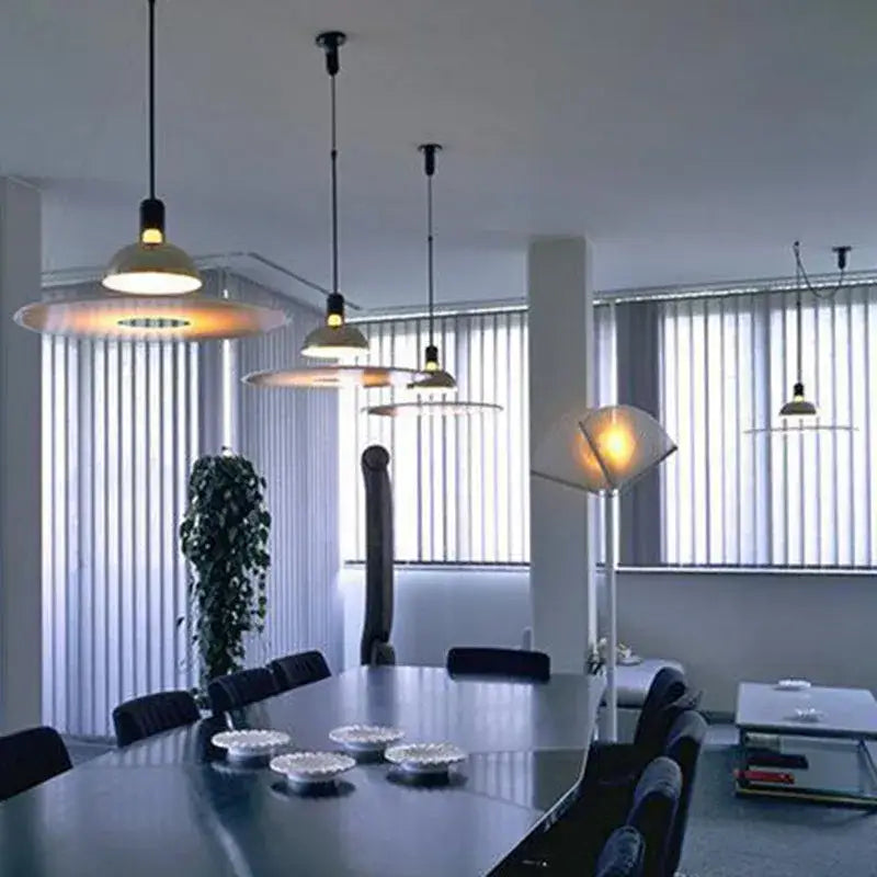 Modern polished brass and white flying saucer chandelier with warm circular shades hanging from black cords decorbites flying saucer
