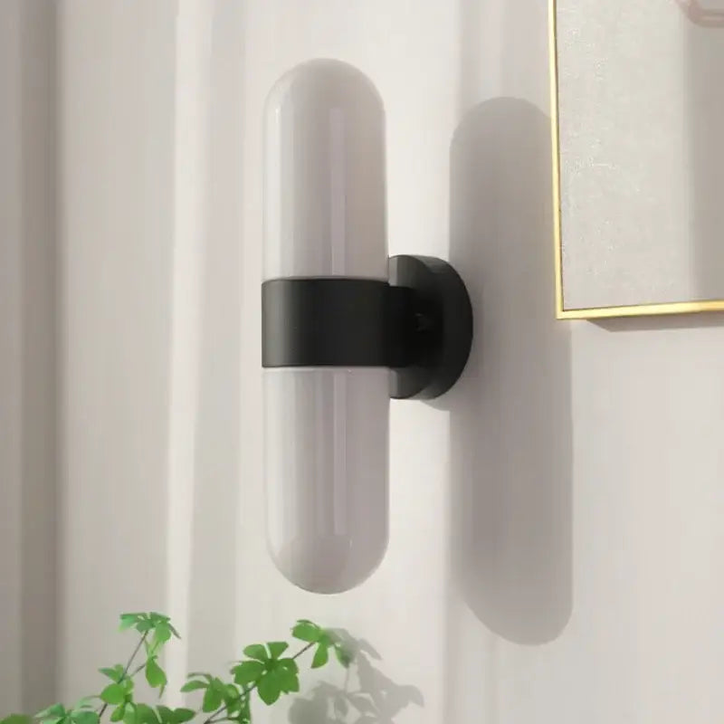 Modern polished chrome led vanity mirror light with minimalist frosted glass shade and matte black metal bracket wall sconce