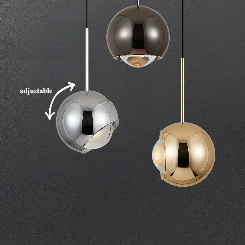 Three polished metallic pendant lights in silver brushed chrome and gold with adjustable angle rods for dining room decorbites pendant light