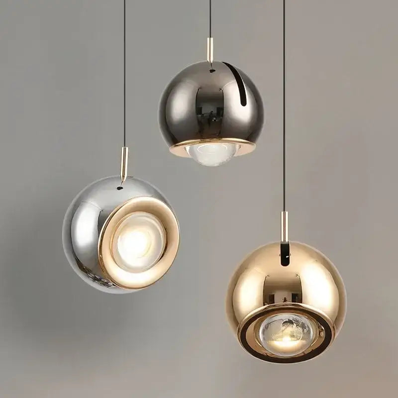 Three polished metallic pendant lights in silver gold and bronze with adjustable angle for modern dining room decorbites