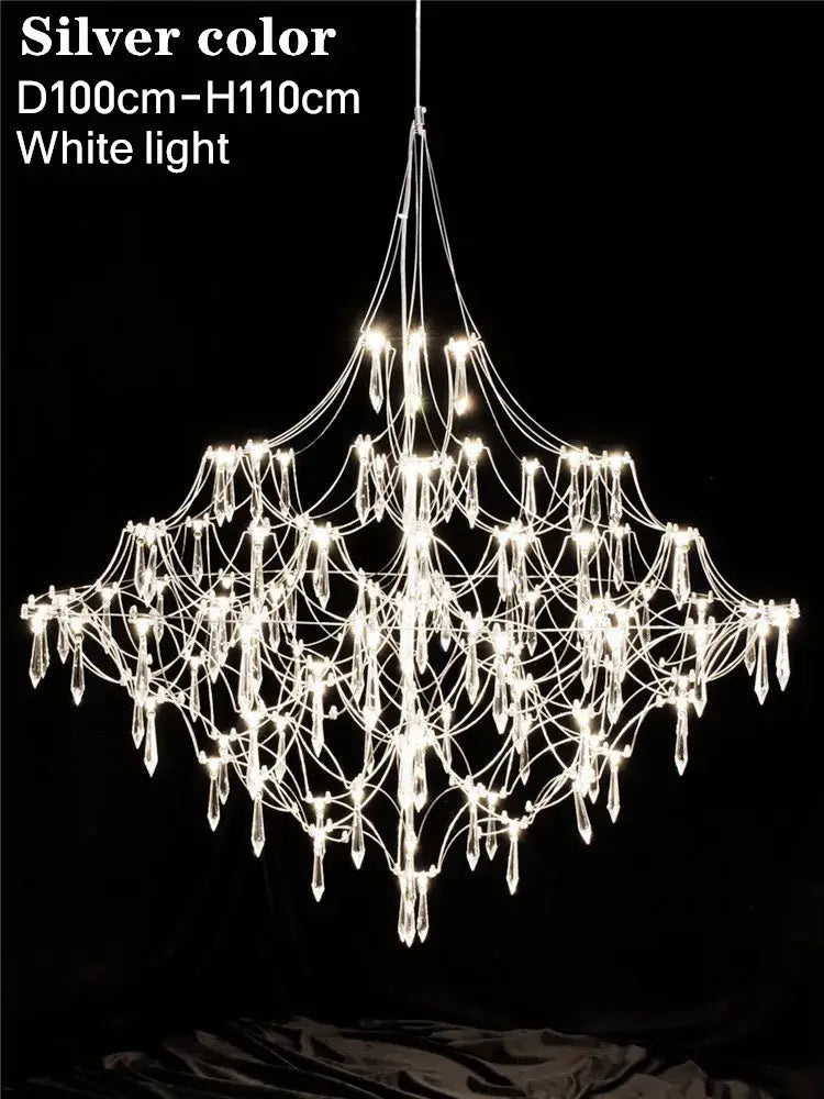 Modern polished steel pendant light with web-like design and crystal pendants illuminated for contemporary interiors