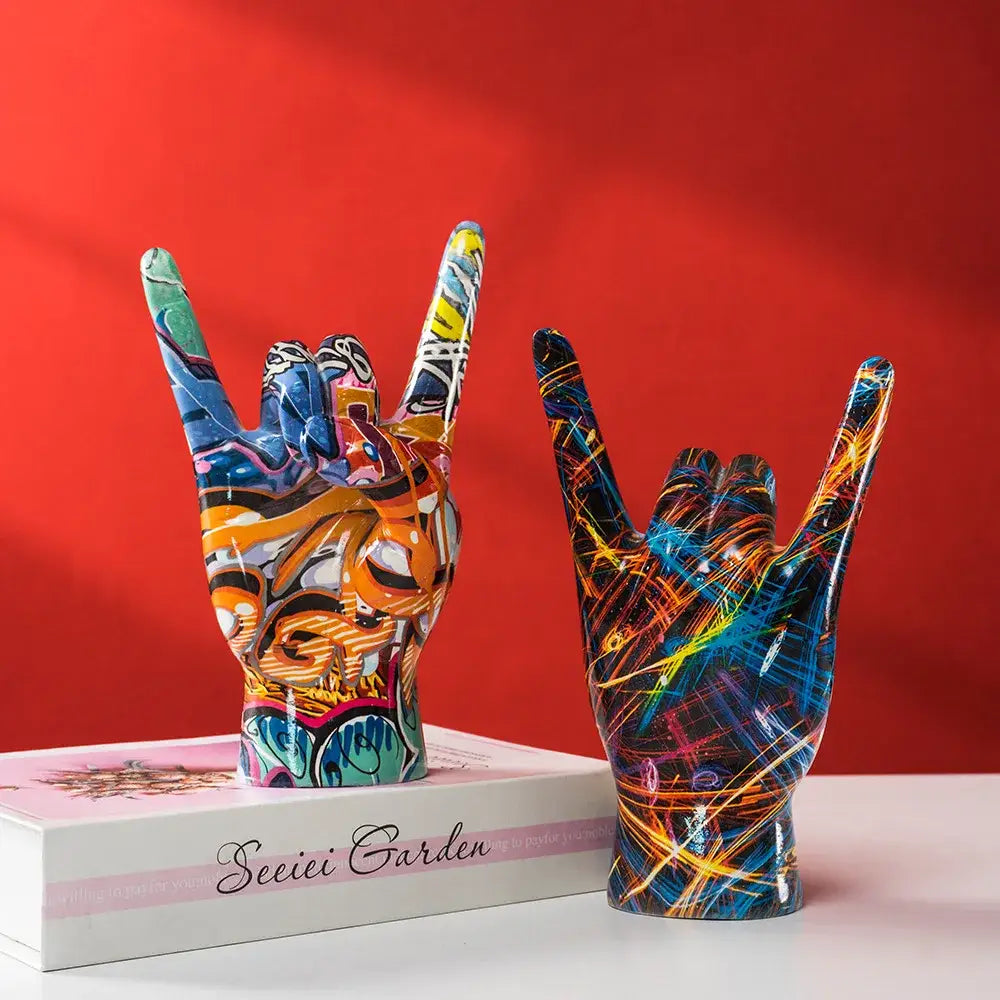 Two vibrant modern pop art hand statues in glossy resin with neon graffiti patterns for living room decor