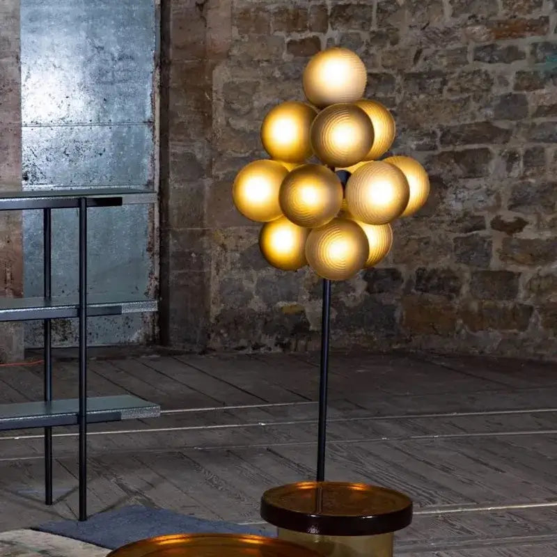 Modern purple decorbites glass bubble floor lamp with golden spherical globe amber glass base and sleek black stand