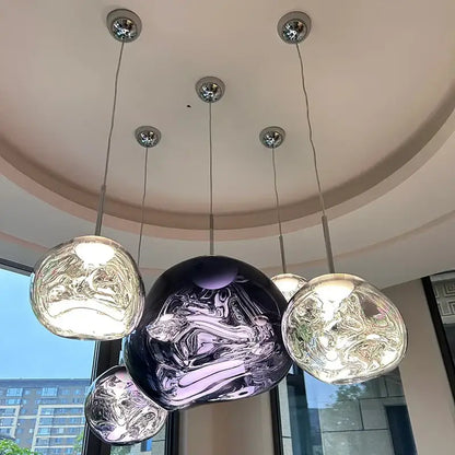 Modern purple lava pendant light with polished chrome finish featuring a spherical glass design and swirling metallic accents