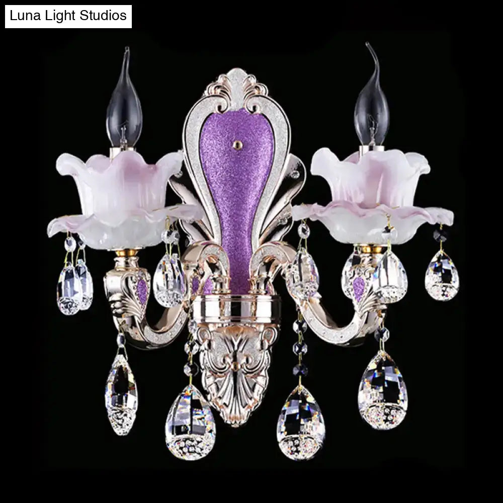 Modern purple and silver crystal wall sconce with pink glass floral accents for elegant bedroom lighting