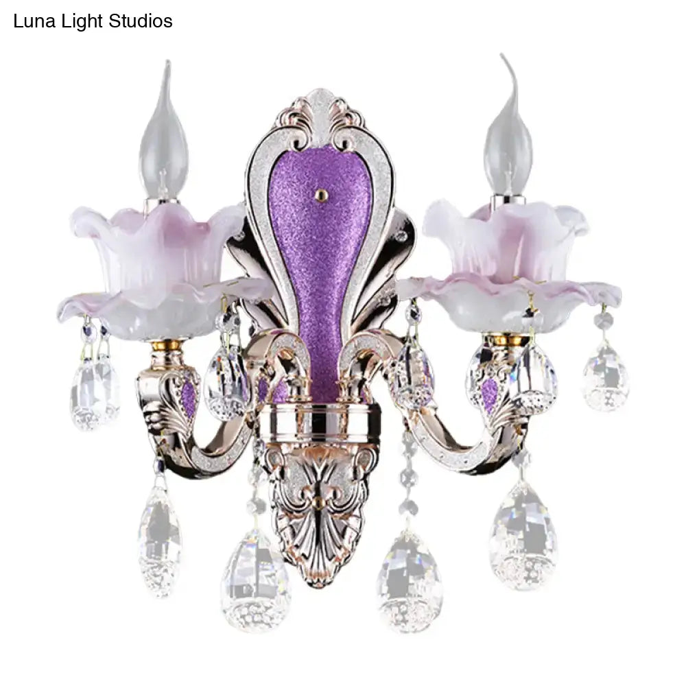 Modern purple and silver crystal wall sconce with lavender glass flower shades and crystal droplets for bedroom lighting