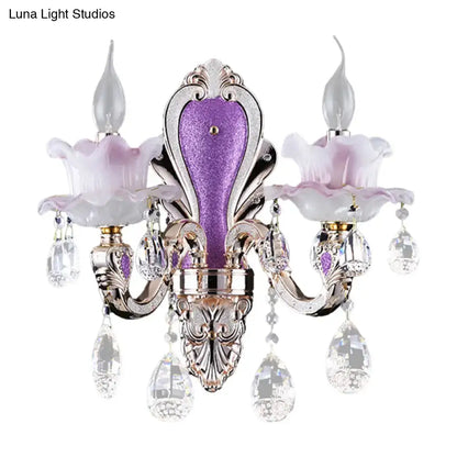Modern purple and silver crystal wall sconce with lavender glass flower shades and crystal droplets for bedroom lighting