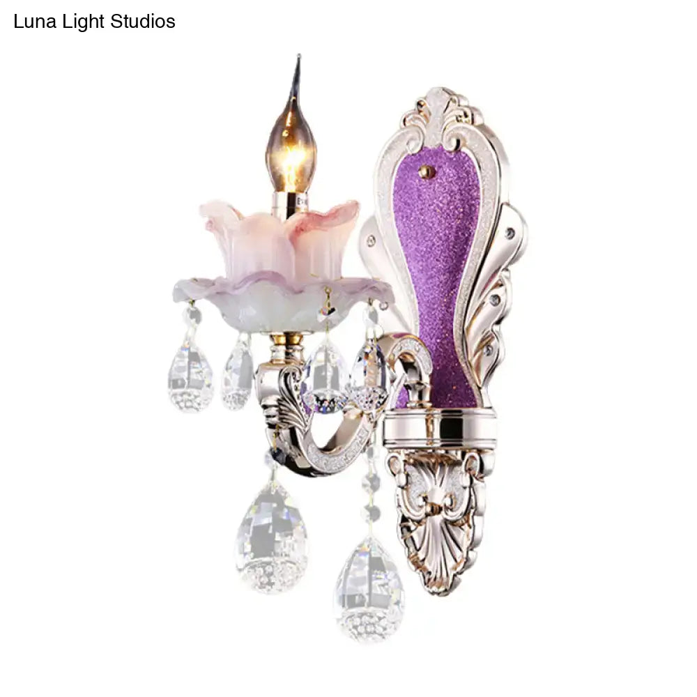 Elegant modern purple and silver crystal wall sconce with pink floral glass shade and crystal teardrop accents for bedroom use