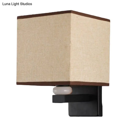 Modern rectangle fabric shade wall light with beige linen lampshade, dark brown trim, black metal base, and faux jade decor