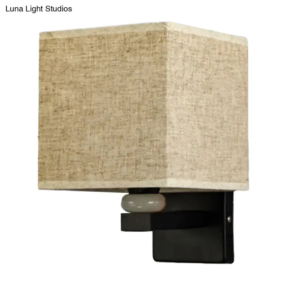 Beige linen-textured fabric shade wall light with black metal base and frosted glass accent for faux jade decor bedroom