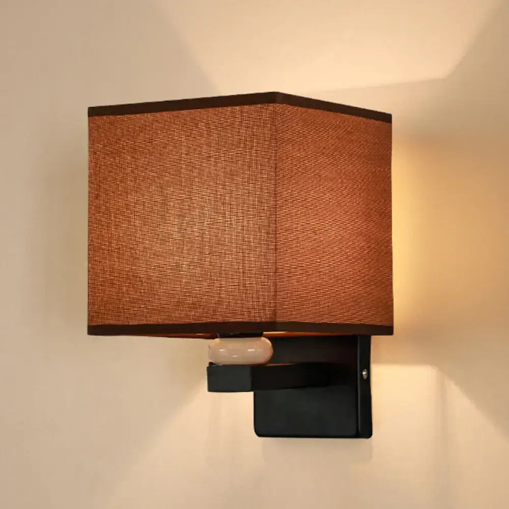 Modern rectangle fabric shade wall light with warm-toned textured brown fabric and black metal bracket for faux jade decor