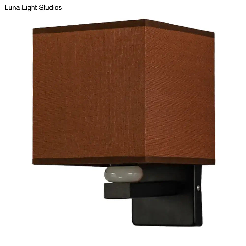 Modern rectangle wall light with brown fabric shade, black metal base, sensor, and faux jade decor for bedroom