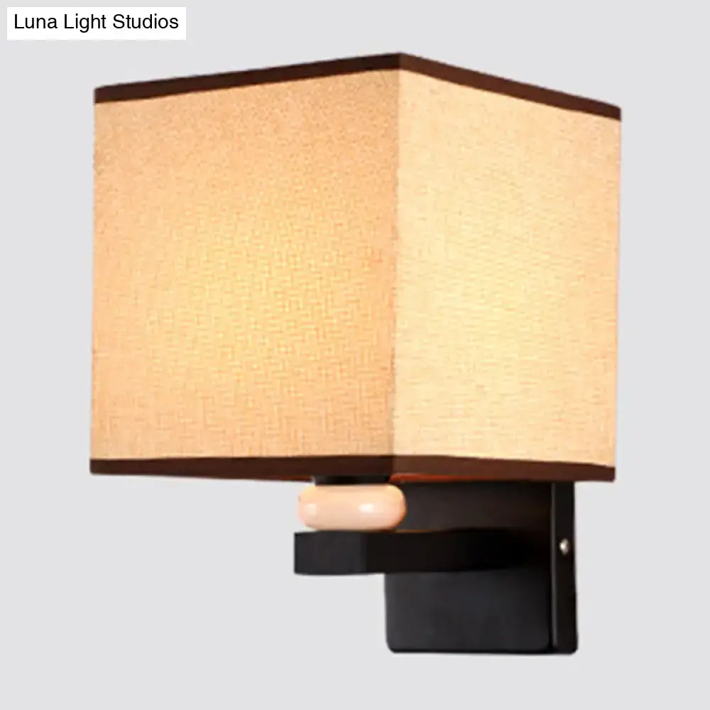 Modern rectangle fabric shade wall light with beige textured fabric shade dark brown trim and faux jade decor base
