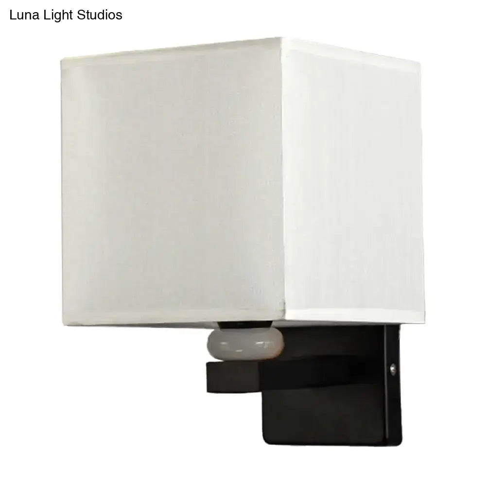 Modern rectangle fabric shade wall light with white frosted glass shade black bracket and faux jade decor bedroom use