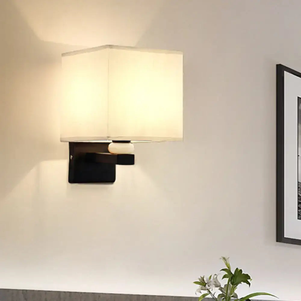 Black wall light with off-white fabric shade and faux jade decor for modern bedroom lighting