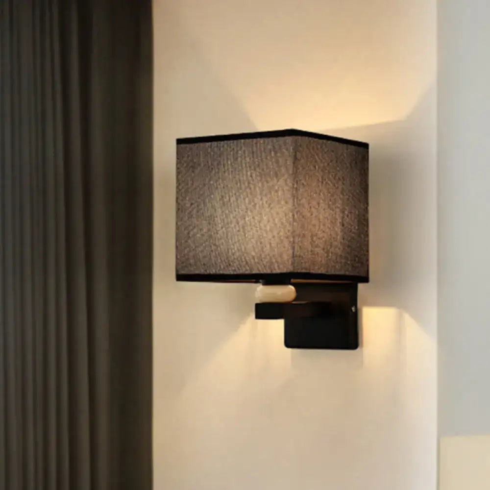 Modern rectangle wall light with black fabric shade and matte metal base featuring faux jade decor for bedroom use