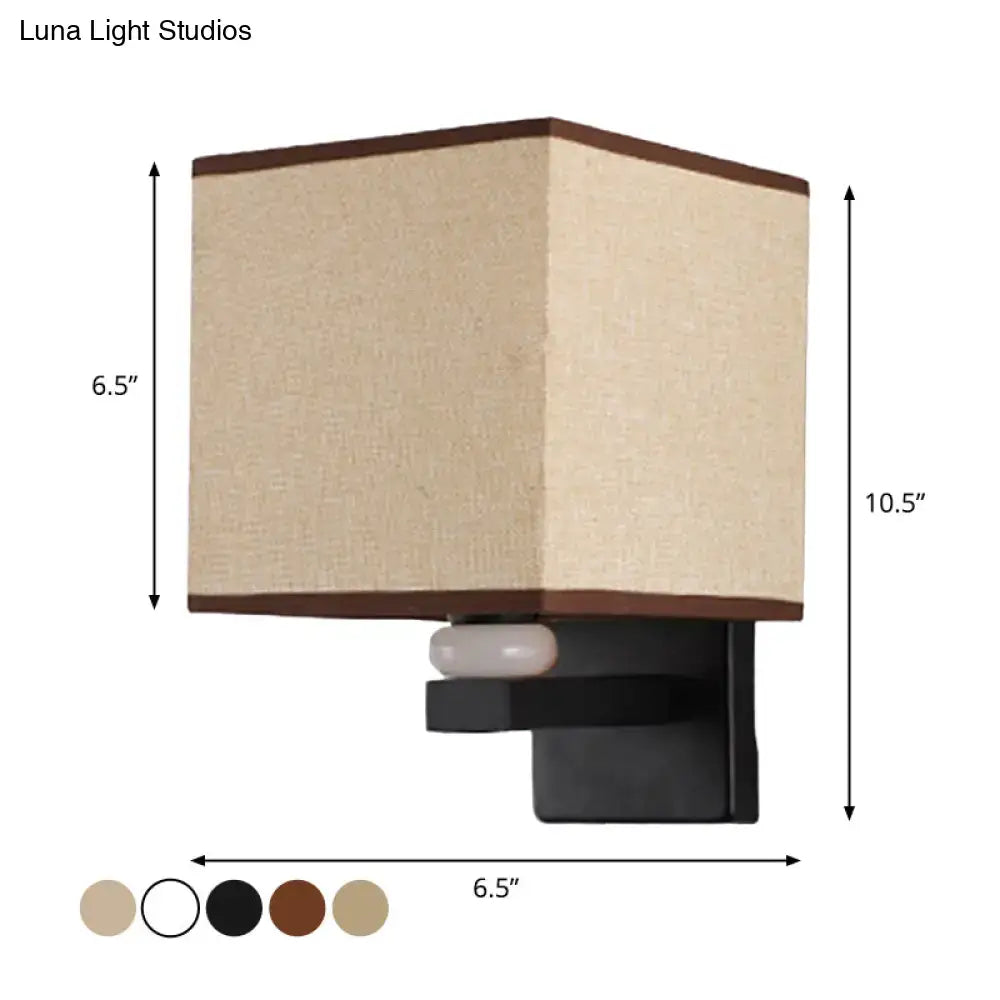 Modern rectangle fabric shade wall light with beige fabric shade brown trim black metal mount and faux jade decor