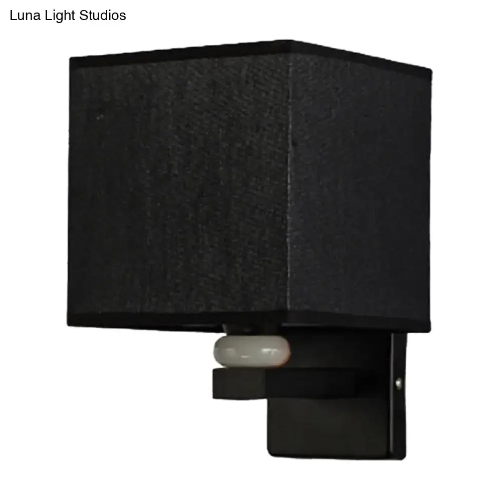 Modern black square wall light with textured fabric shade and sleek metal base for faux jade decor bedroom
