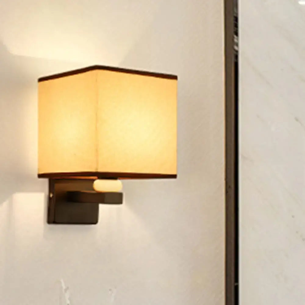 Modern rectangle fabric shade wall light with warm-toned square fabric shade and dark metal base featuring faux jade decor