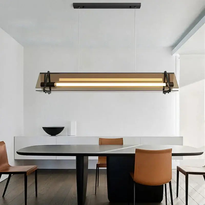 Modern rectangular amber led pendant lamp with sleek black metal frame and amber glass panels for dining room decorbites amber led
