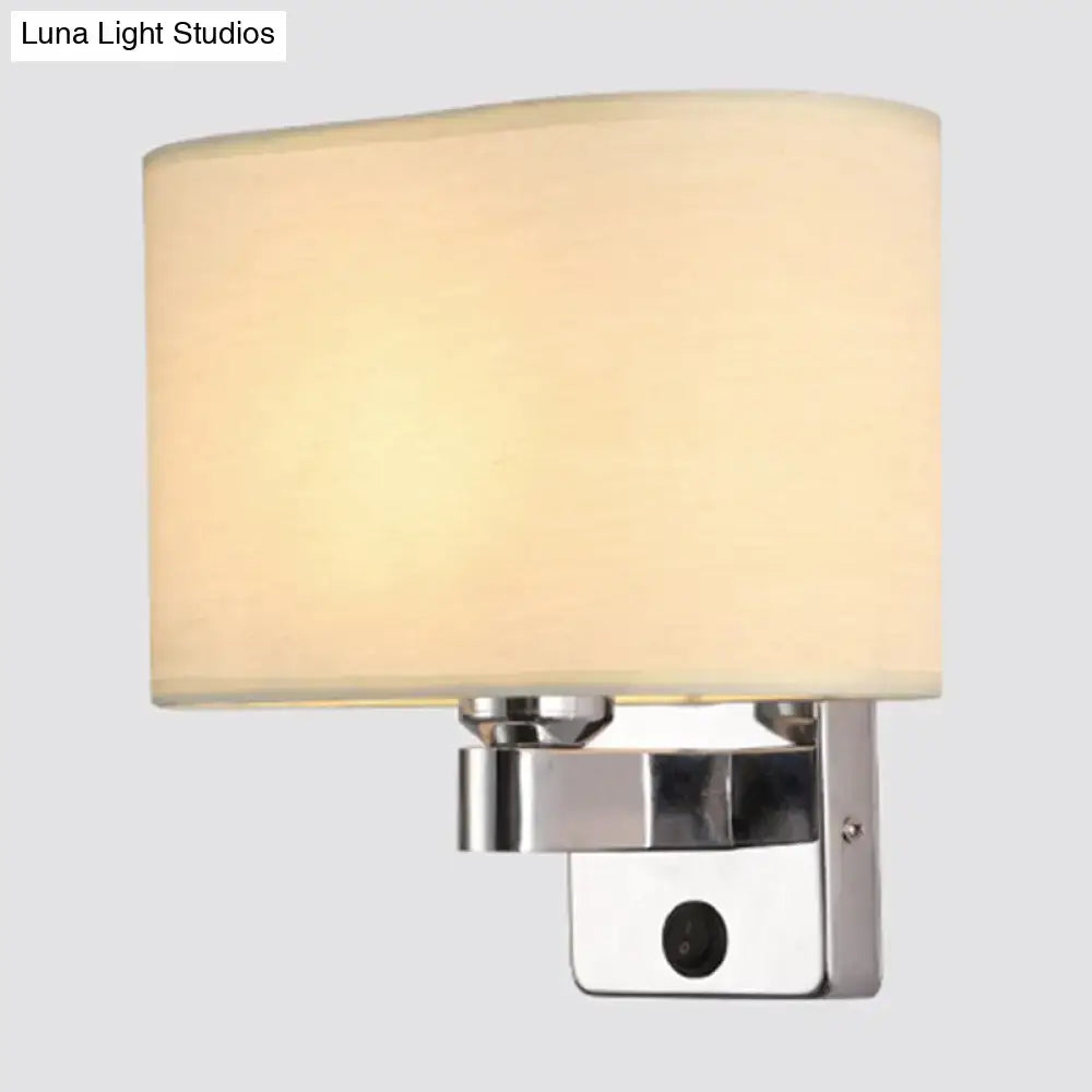 Modern rectangular chrome wall sconce with cylindrical white beige fabric shade for bedroom lighting in black white beige decor