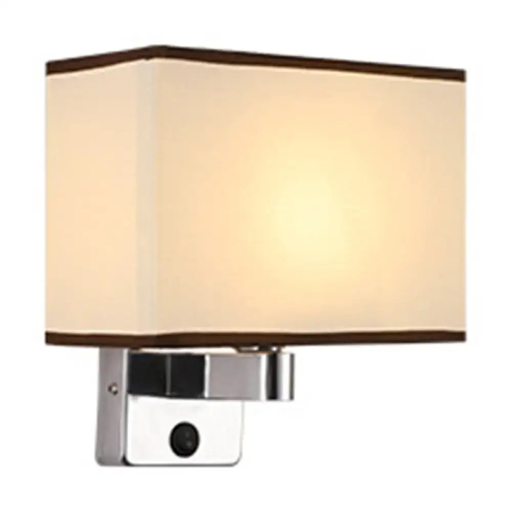 Modern rectangular chrome wall sconce with a black white beige fabric shade and polished metal base for bedroom lighting