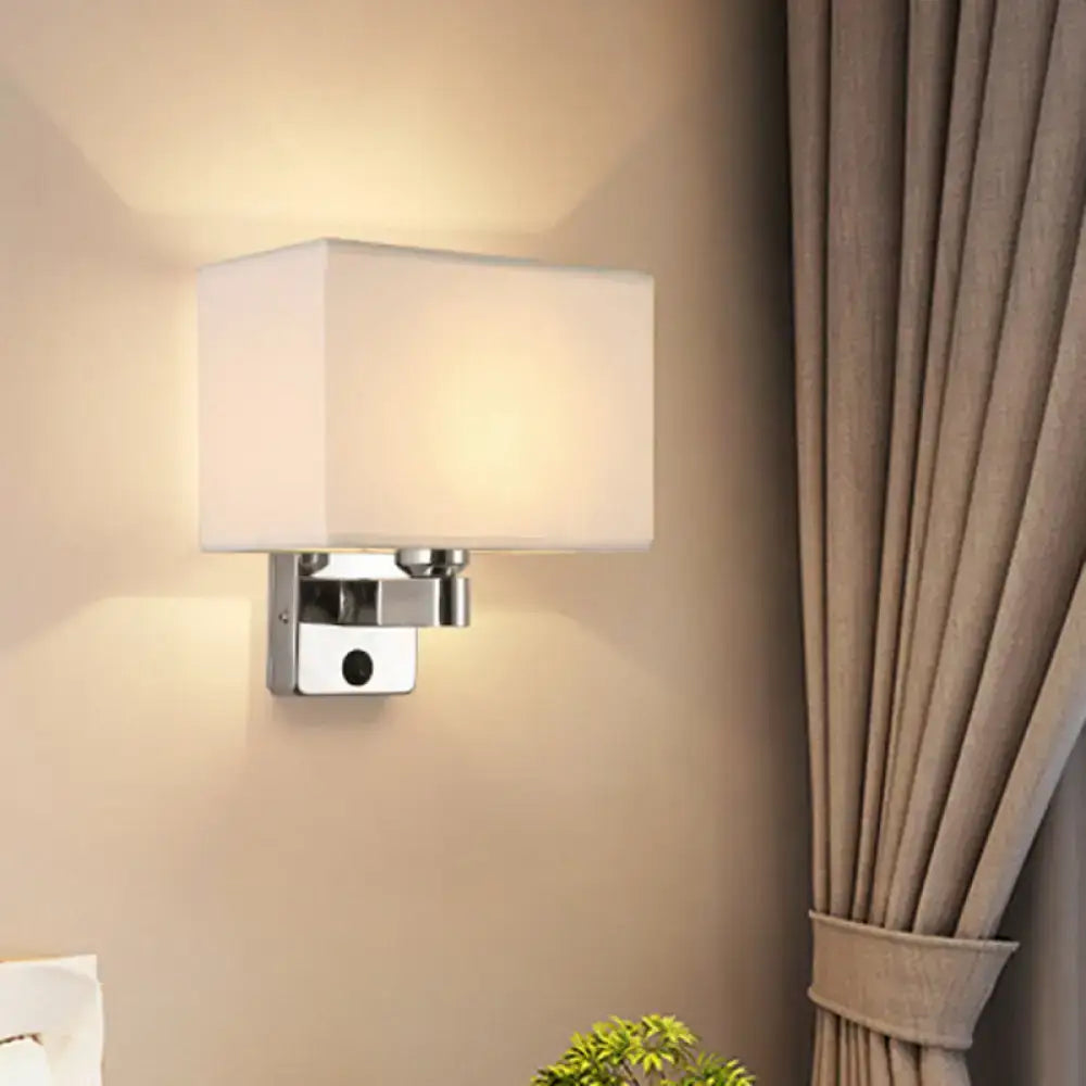 Modern rectangular chrome wall sconce with white beige fabric shade and metal base for bedroom lighting