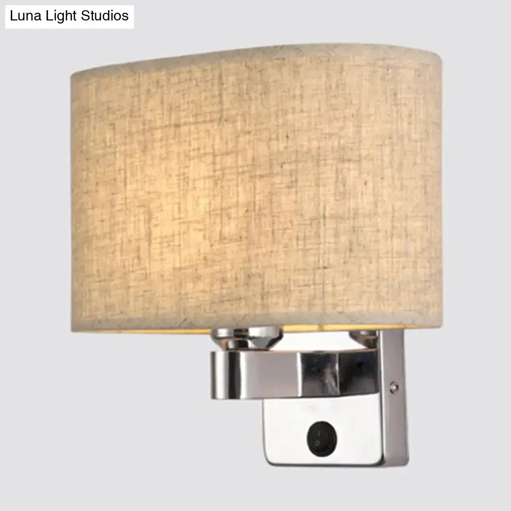 Modern rectangular chrome wall sconce with white beige fabric shade and beige linen-textured cylindrical light for bedroom use